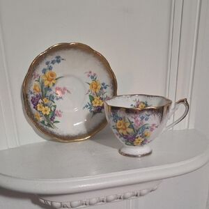 This is a vintage Queen Anne "Spring Song" bone china teacup and saucer set. 